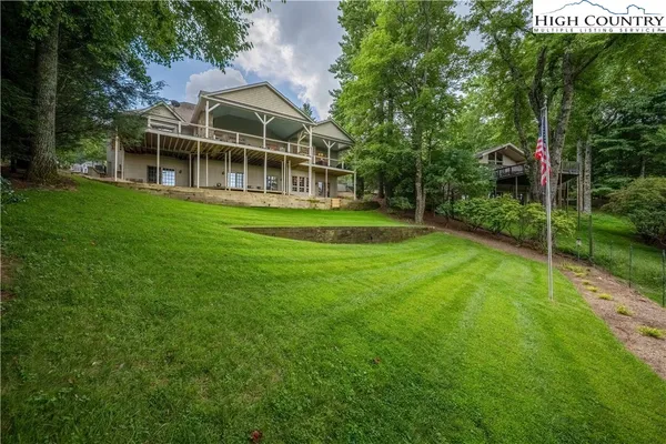 a kitchen with a stove a sink dishwasher a kitchen island with wooden cabinets and floor