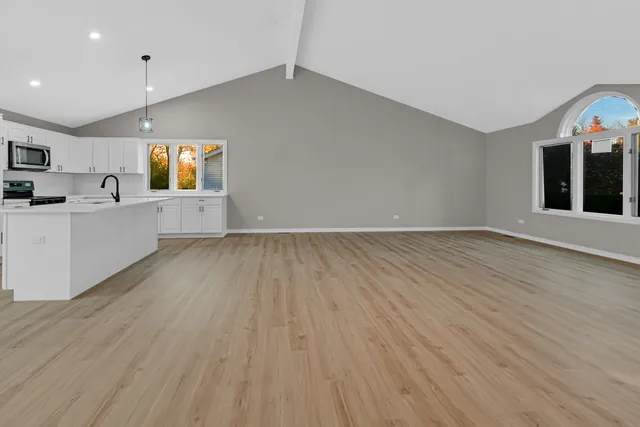 a front view of a house with a garden and yard