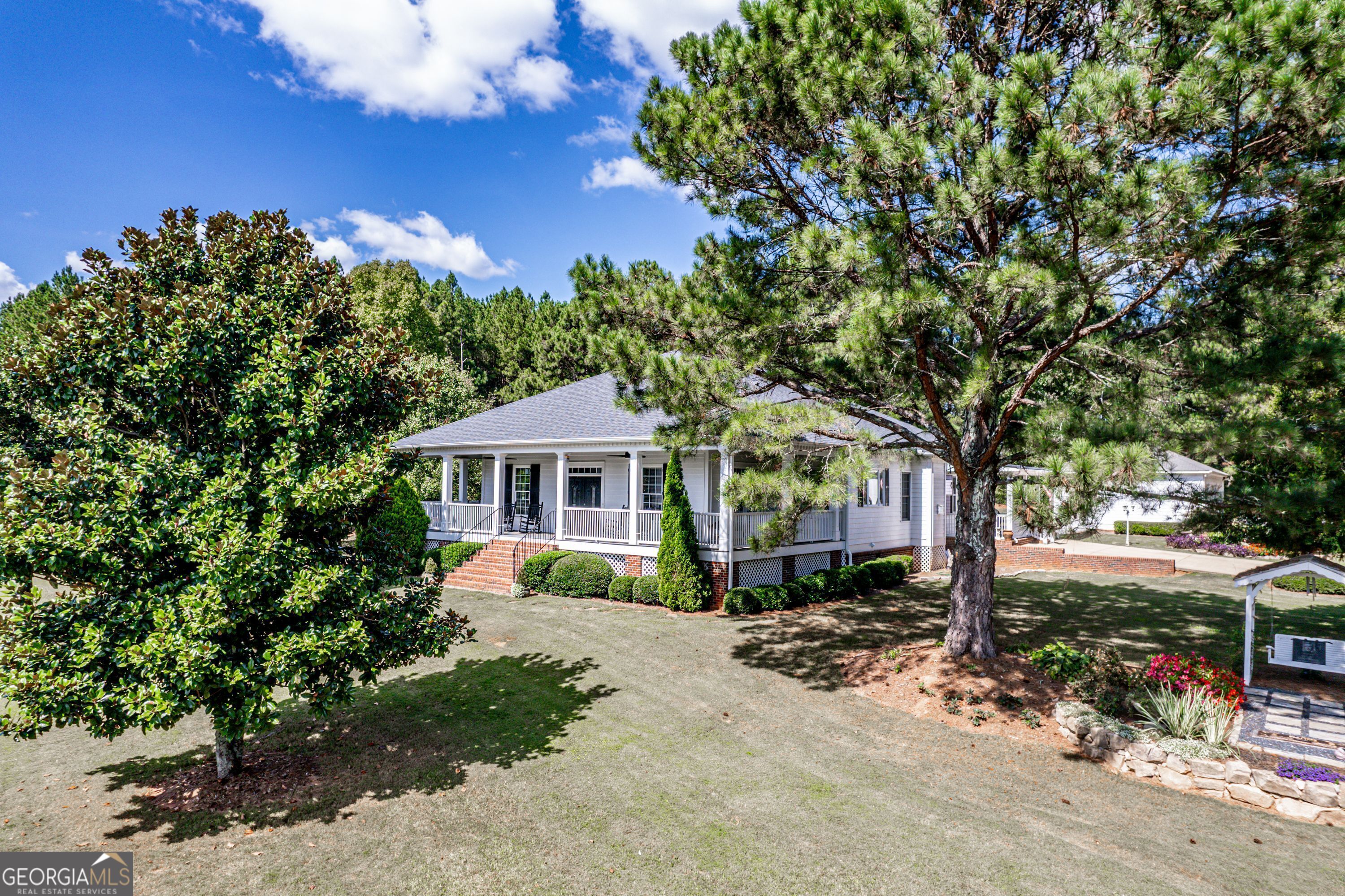 1750 Double Bridges Road Good Hope, GA 30641 - Photo 1 of 1 a front view of a house with a garden