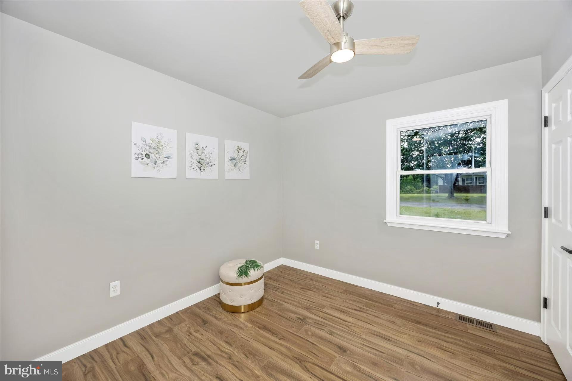 1212 Random Ridge Road Westminster, MD 21157 - Photo 15 of 36 a view of an empty room with a window and wooden floor