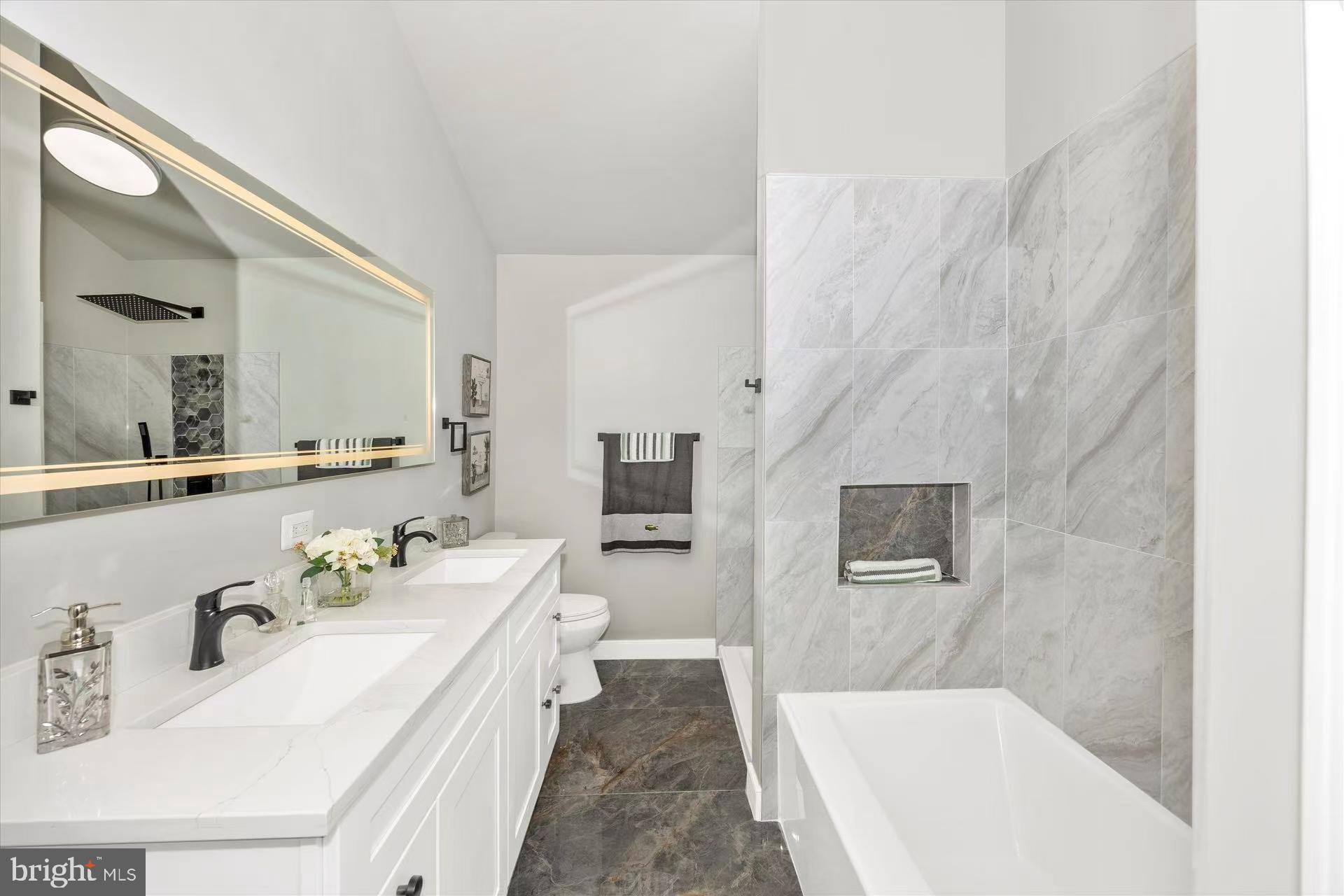 1212 Random Ridge Road Westminster, MD 21157 - Photo 26 of 36 a spacious bathroom with a tub sink and mirror