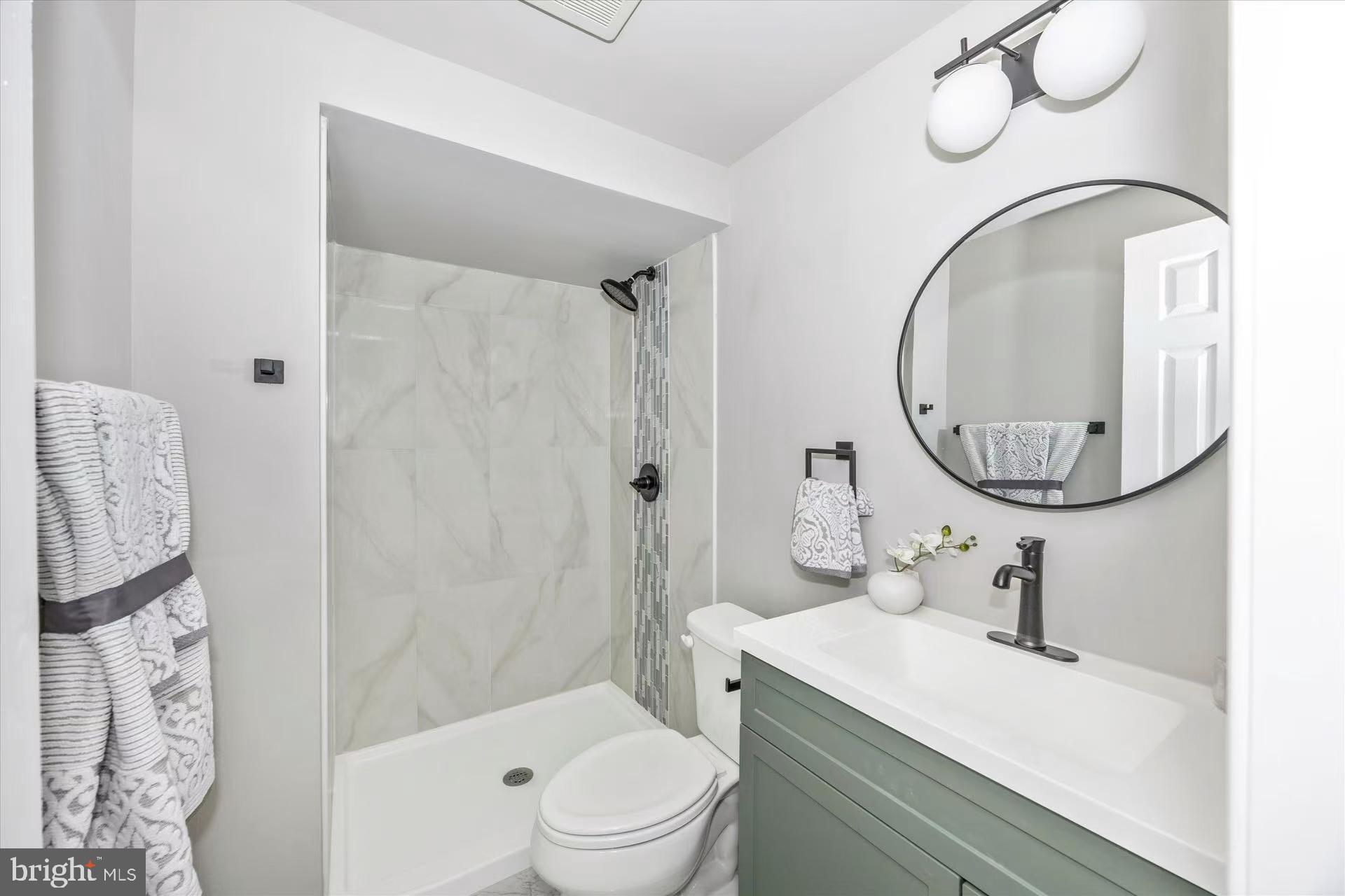 1212 Random Ridge Road Westminster, MD 21157 - Photo 28 of 36 a bathroom with a sink a mirror a toilet and a shower