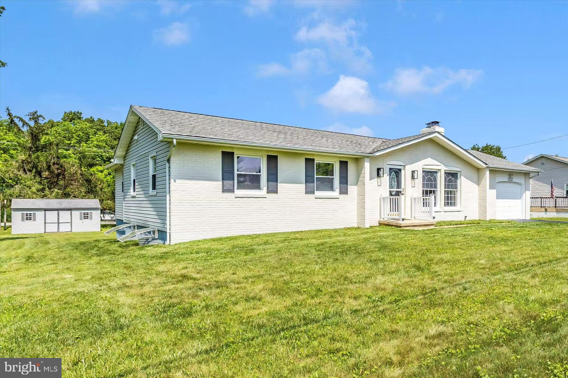 1212 Random Ridge Road Westminster, MD 21157 - Photo 3 of 36 a view of a yard in front of a house with a large tree