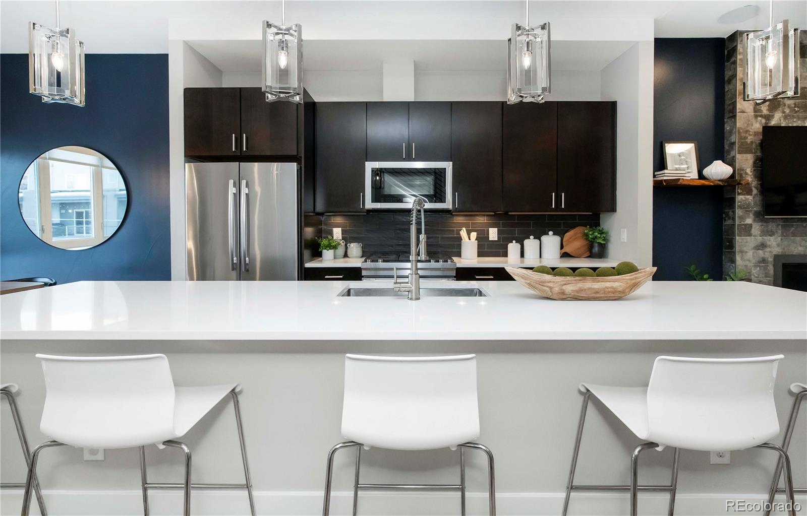 1933 Grove Street Denver, CO 80204 - Photo 12 of 29 a kitchen with cabinets and chairs