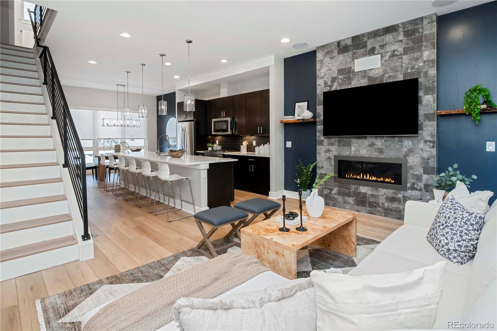 1933 Grove Street Denver, CO 80204 - Photo 13 of 29 a living room with furniture a flat screen tv and a fireplace