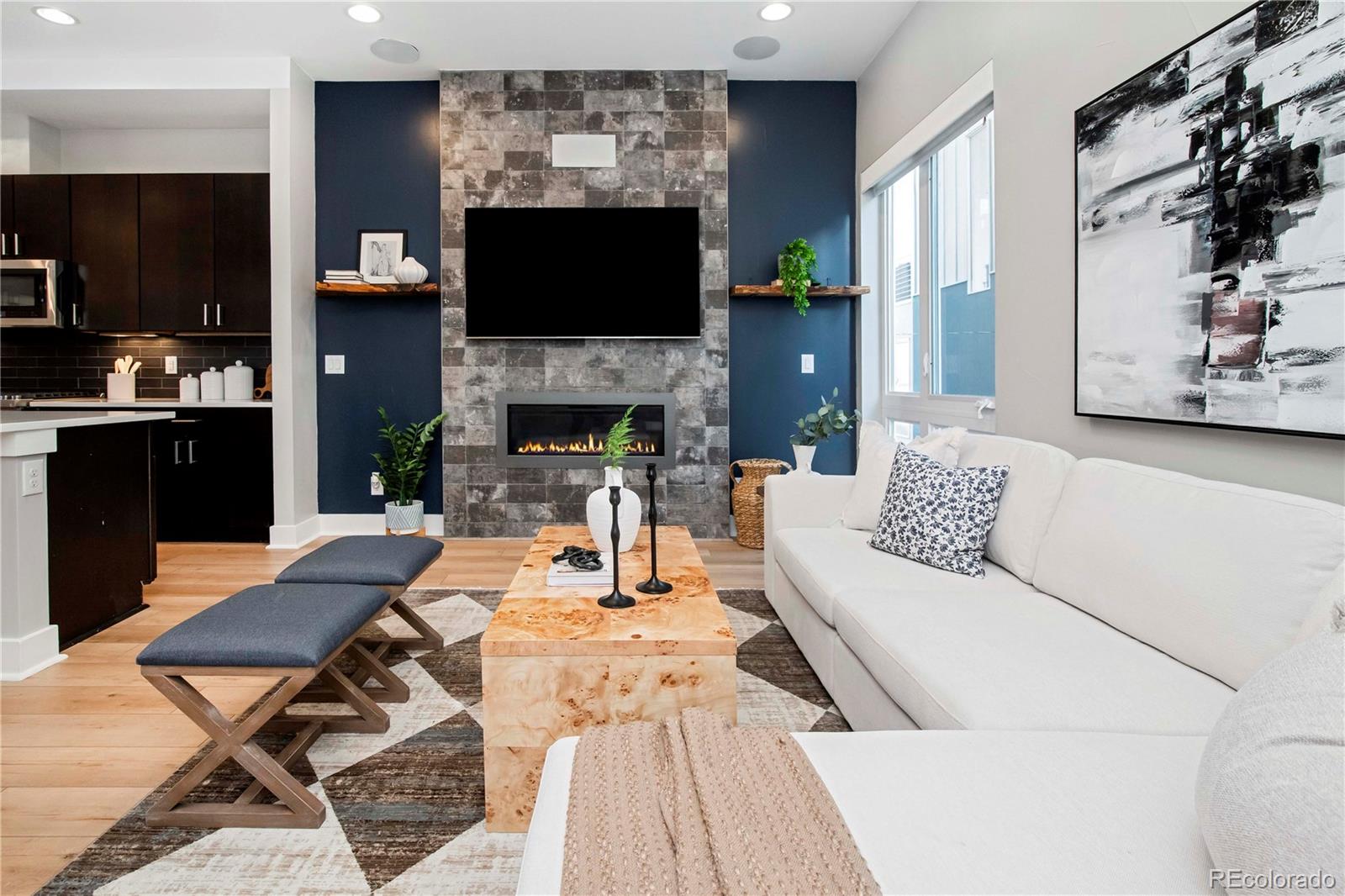 1933 Grove Street Denver, CO 80204 - Photo 14 of 29 a living room with furniture a flat screen tv and a fireplace