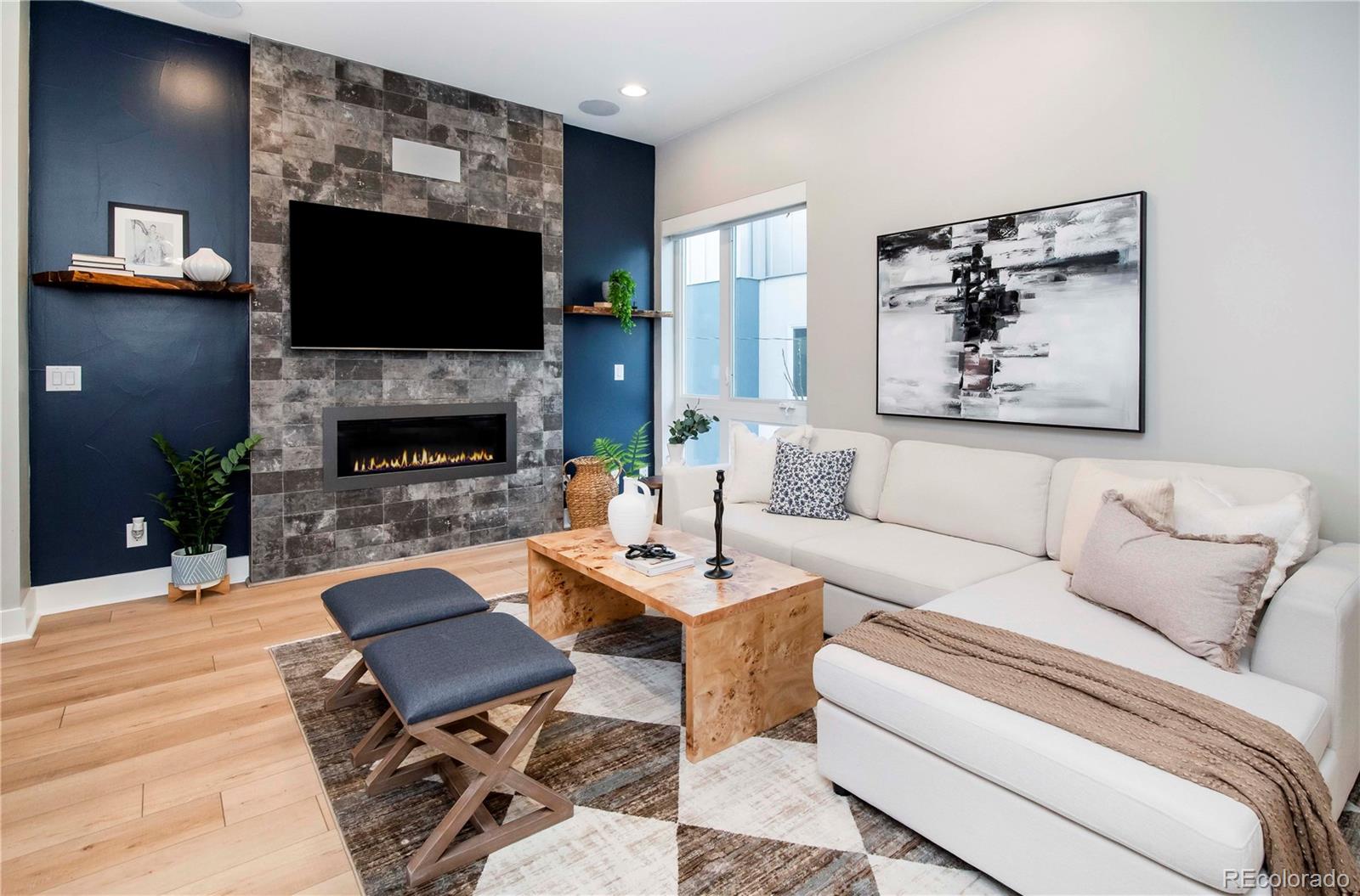 1933 Grove Street Denver, CO 80204 - Photo 15 of 29 a living room with furniture a flat screen tv and a fireplace