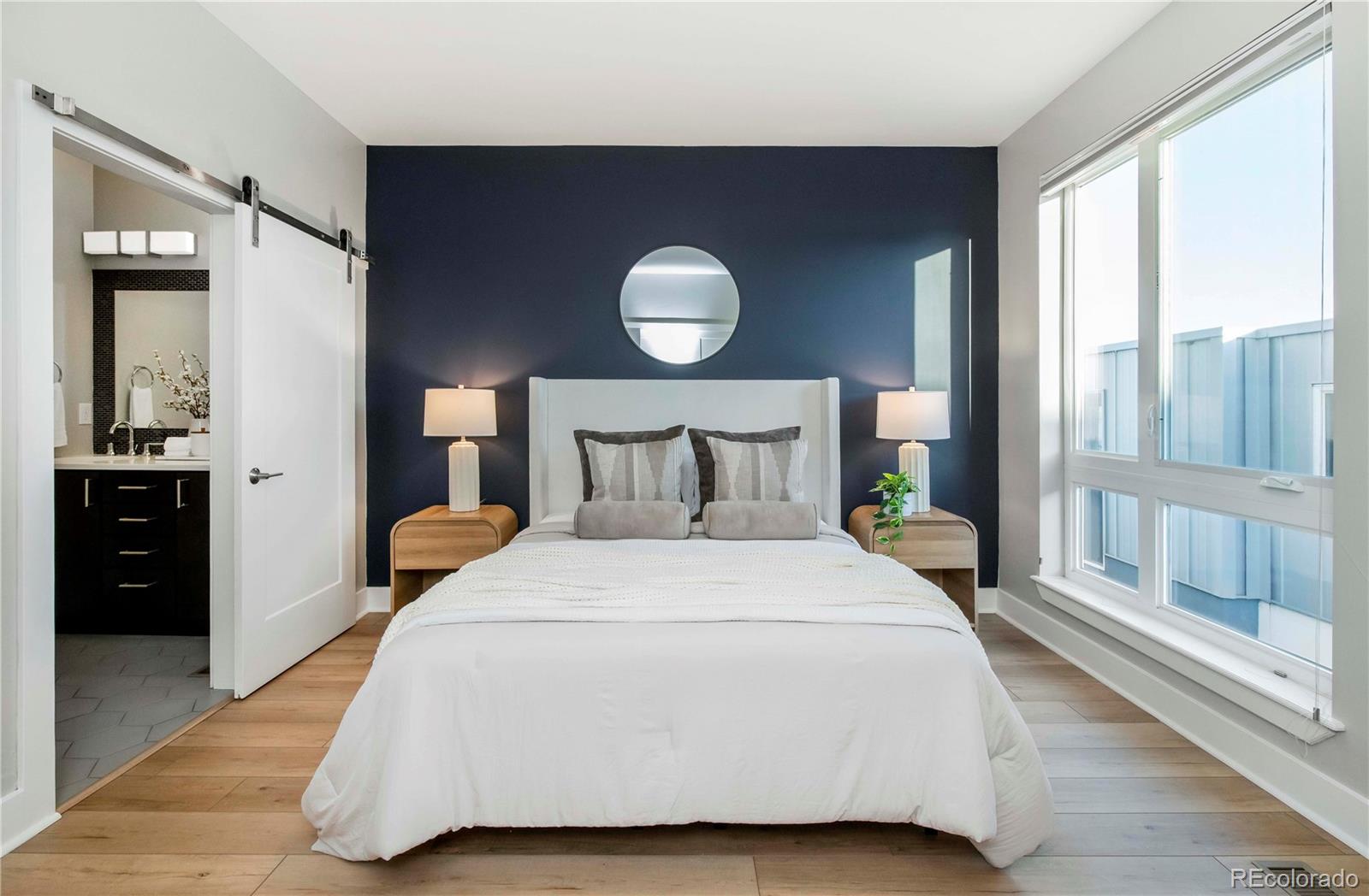 1933 Grove Street Denver, CO 80204 - Photo 16 of 29 a large bed sitting in a bedroom next to a window