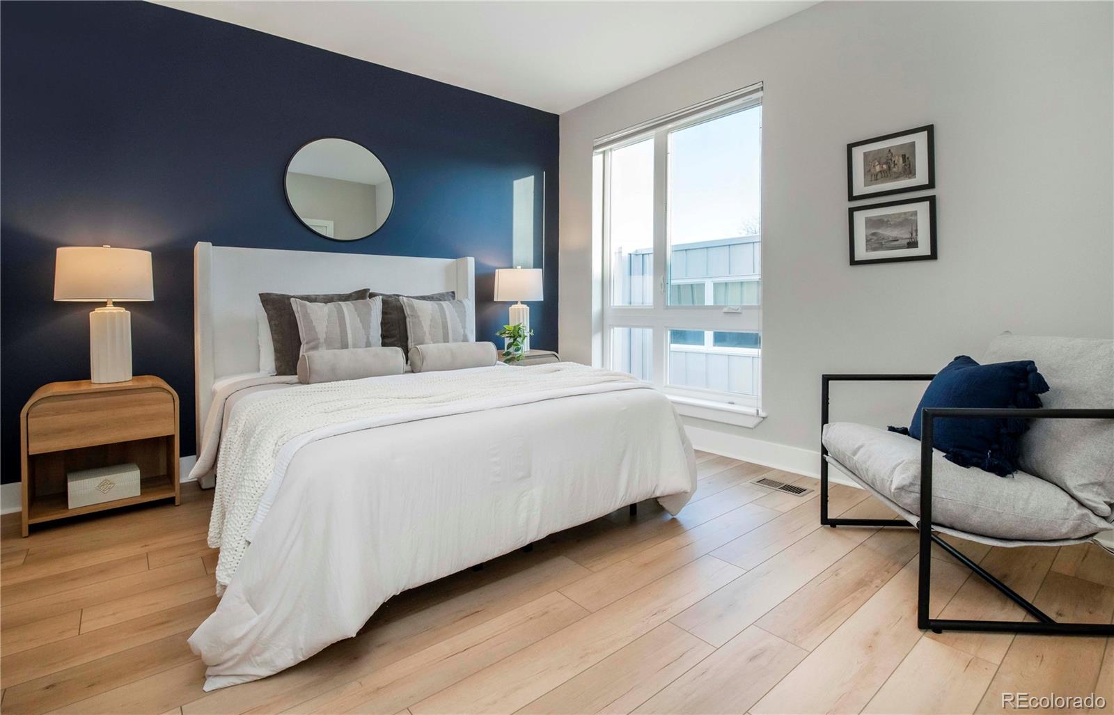 1933 Grove Street Denver, CO 80204 - Photo 17 of 29 a bedroom with a bed chair and wooden floor