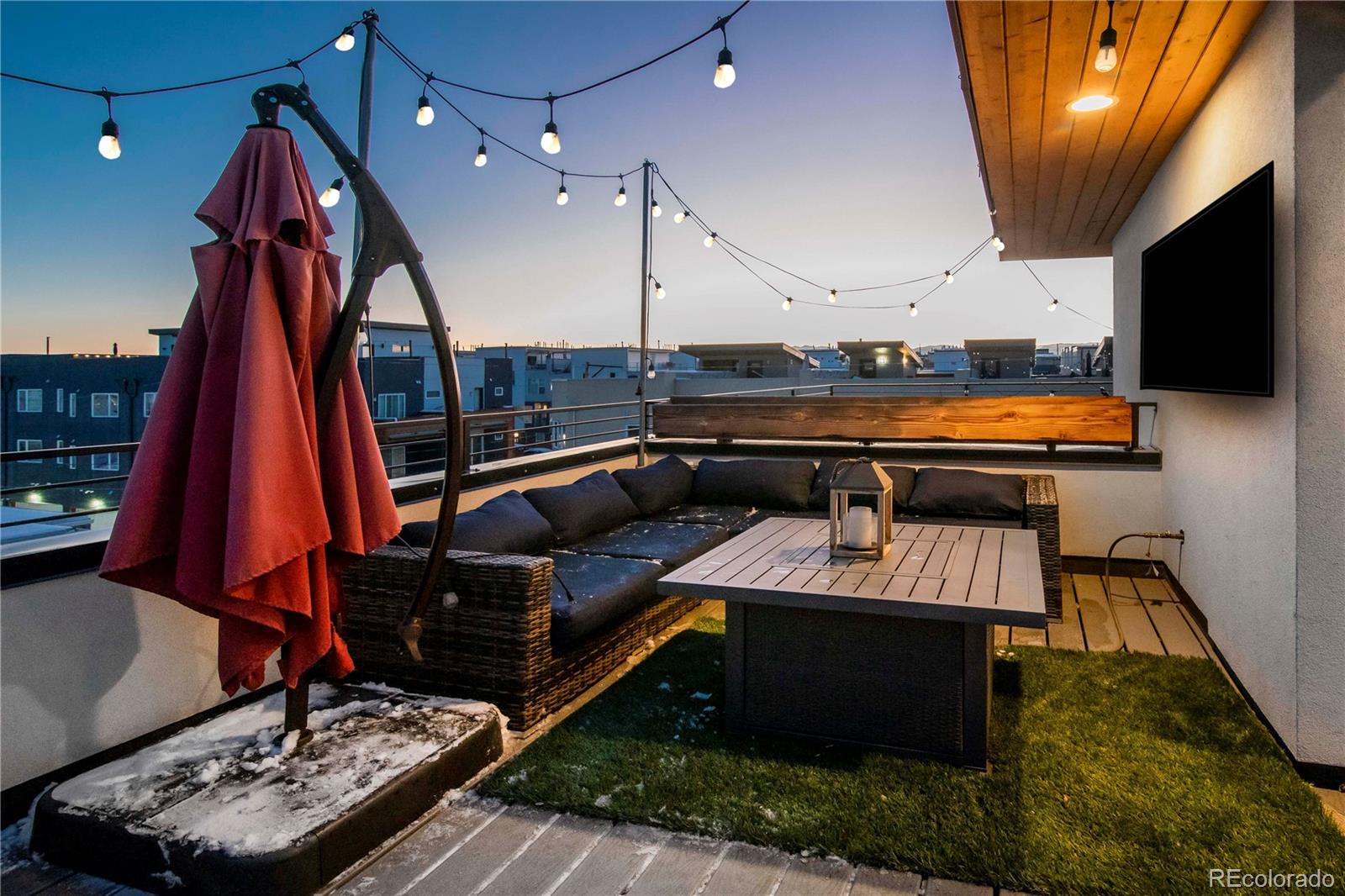 1933 Grove Street Denver, CO 80204 - Photo 27 of 29 a living room with furniture a flat screen tv and a fireplace