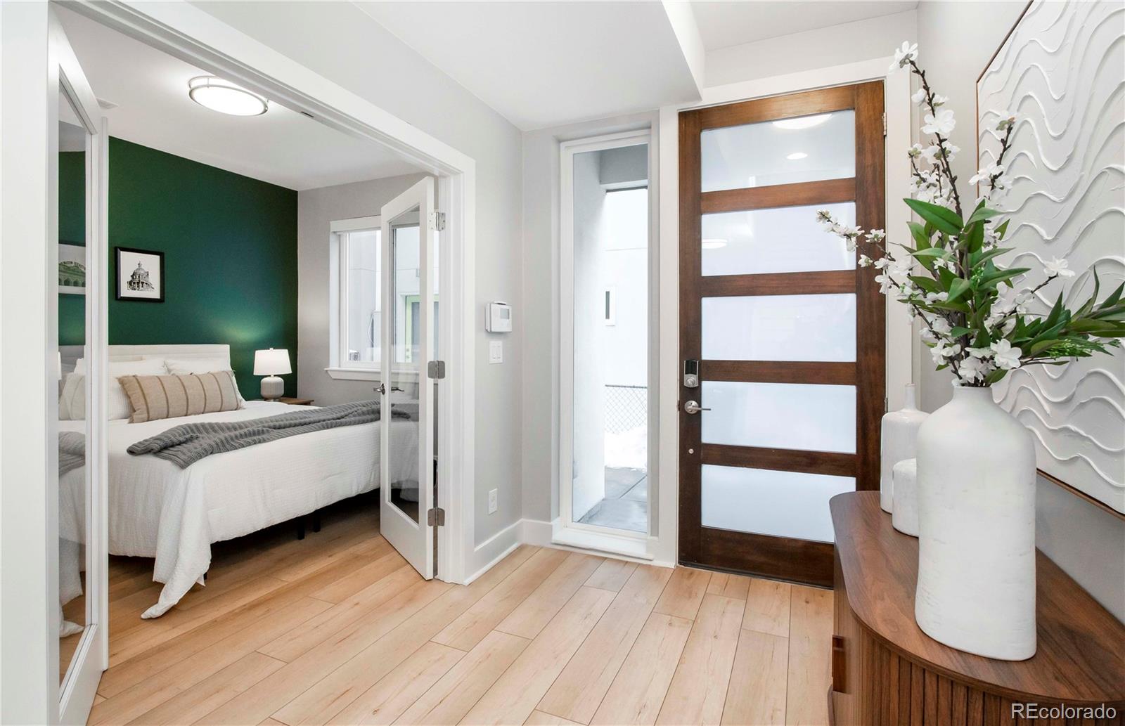 1933 Grove Street Denver, CO 80204 - Photo 6 of 29 a bedroom with furniture and a window