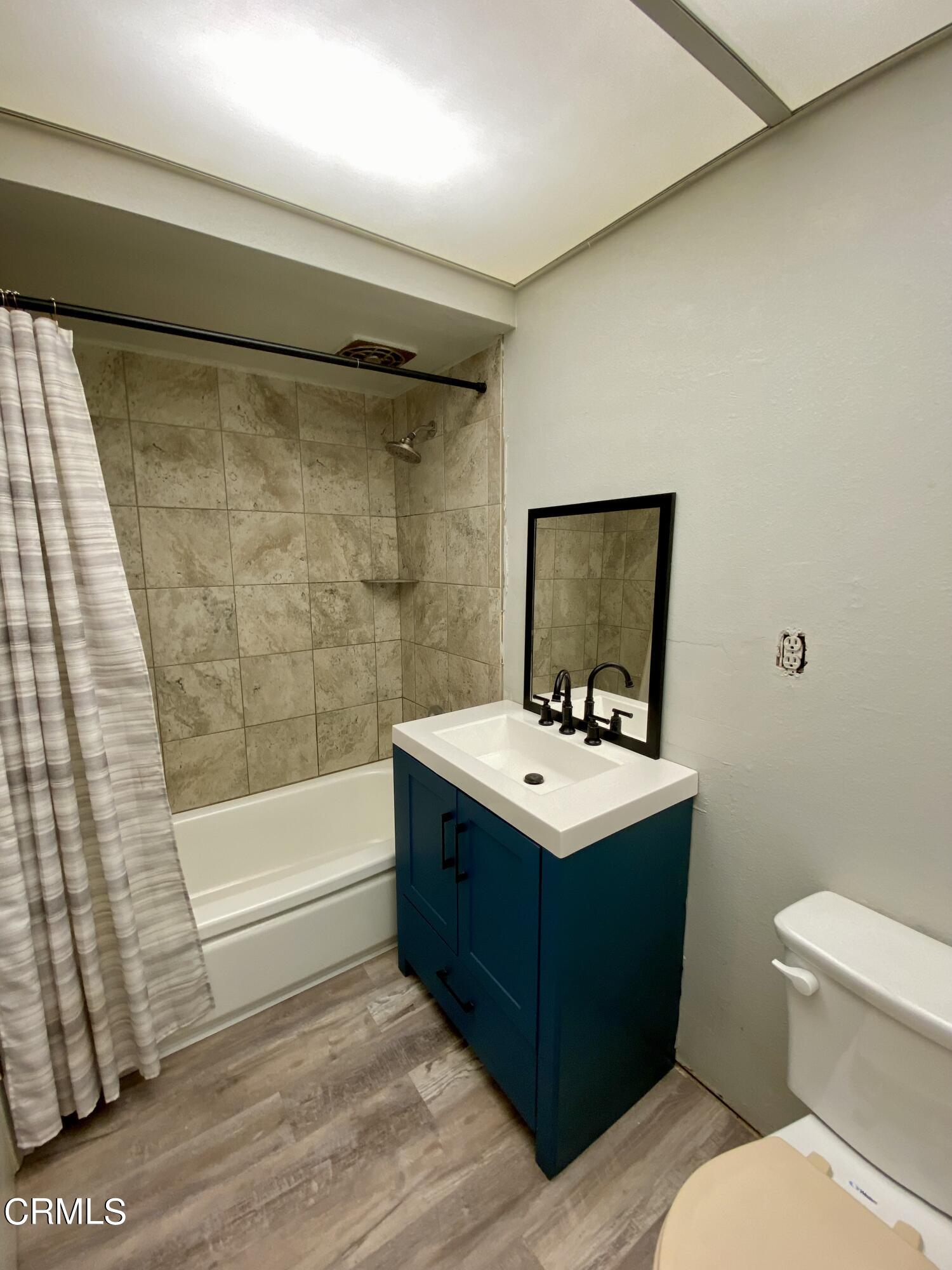 930 West Olive Street Oxnard, CA 93033 - Photo 12 of 22 a bathroom with a sink mirror toilet and bathtub