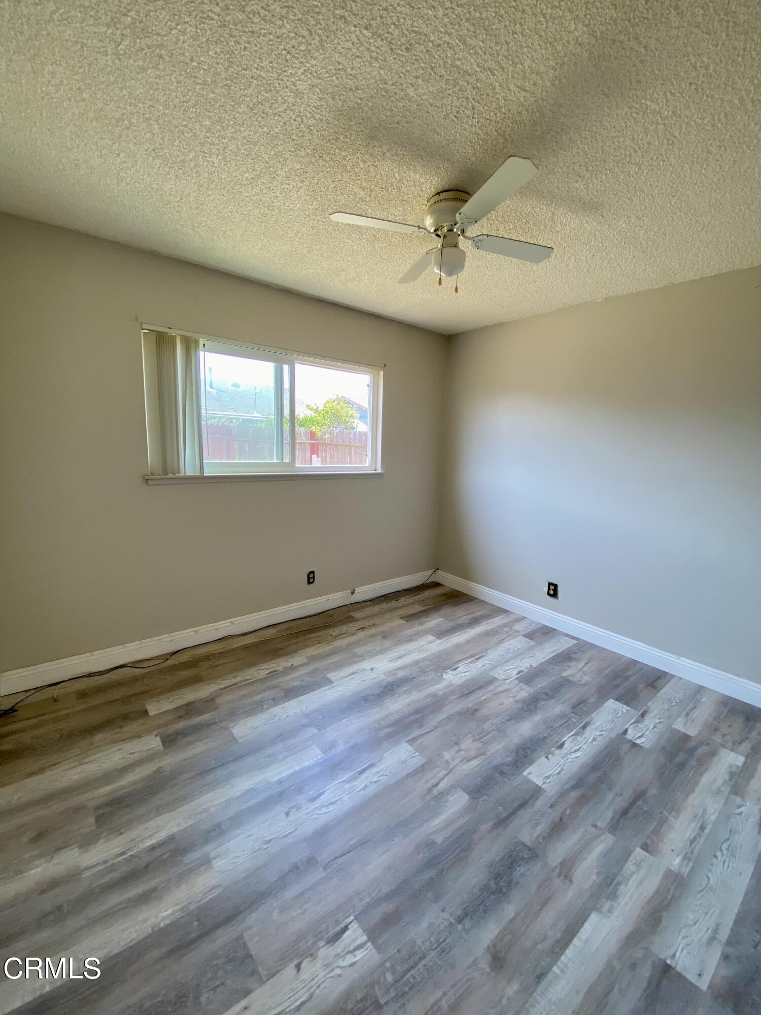 930 West Olive Street Oxnard, CA 93033 - Photo 14 of 22 an empty room with wooden floor and windows