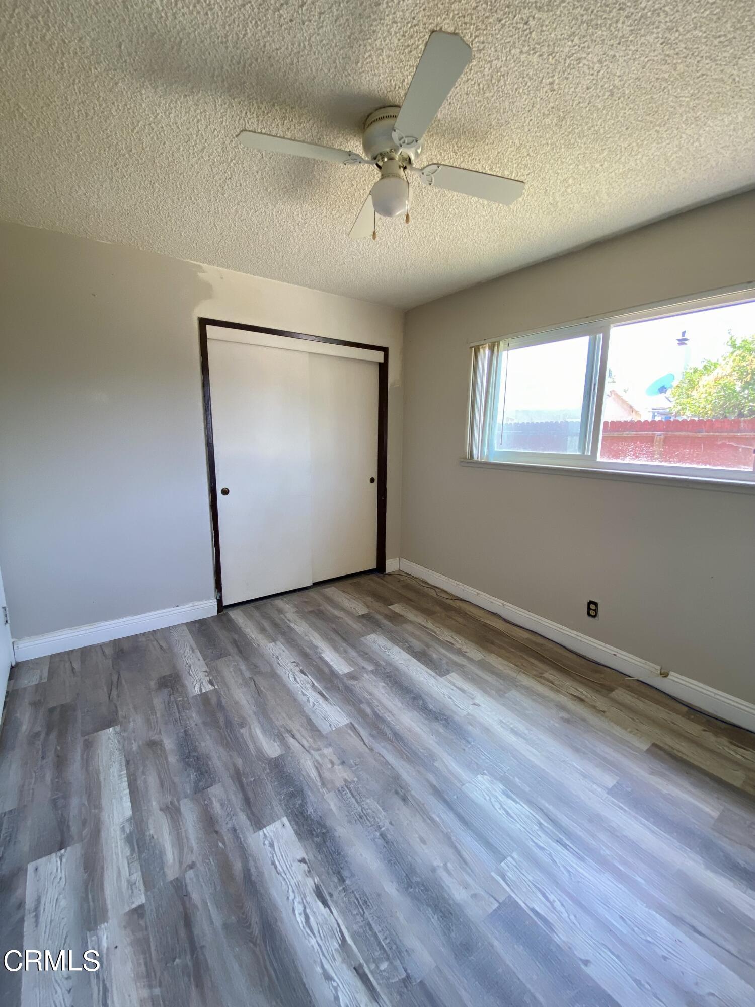 930 West Olive Street Oxnard, CA 93033 - Photo 15 of 22 an empty room with wooden floor and windows