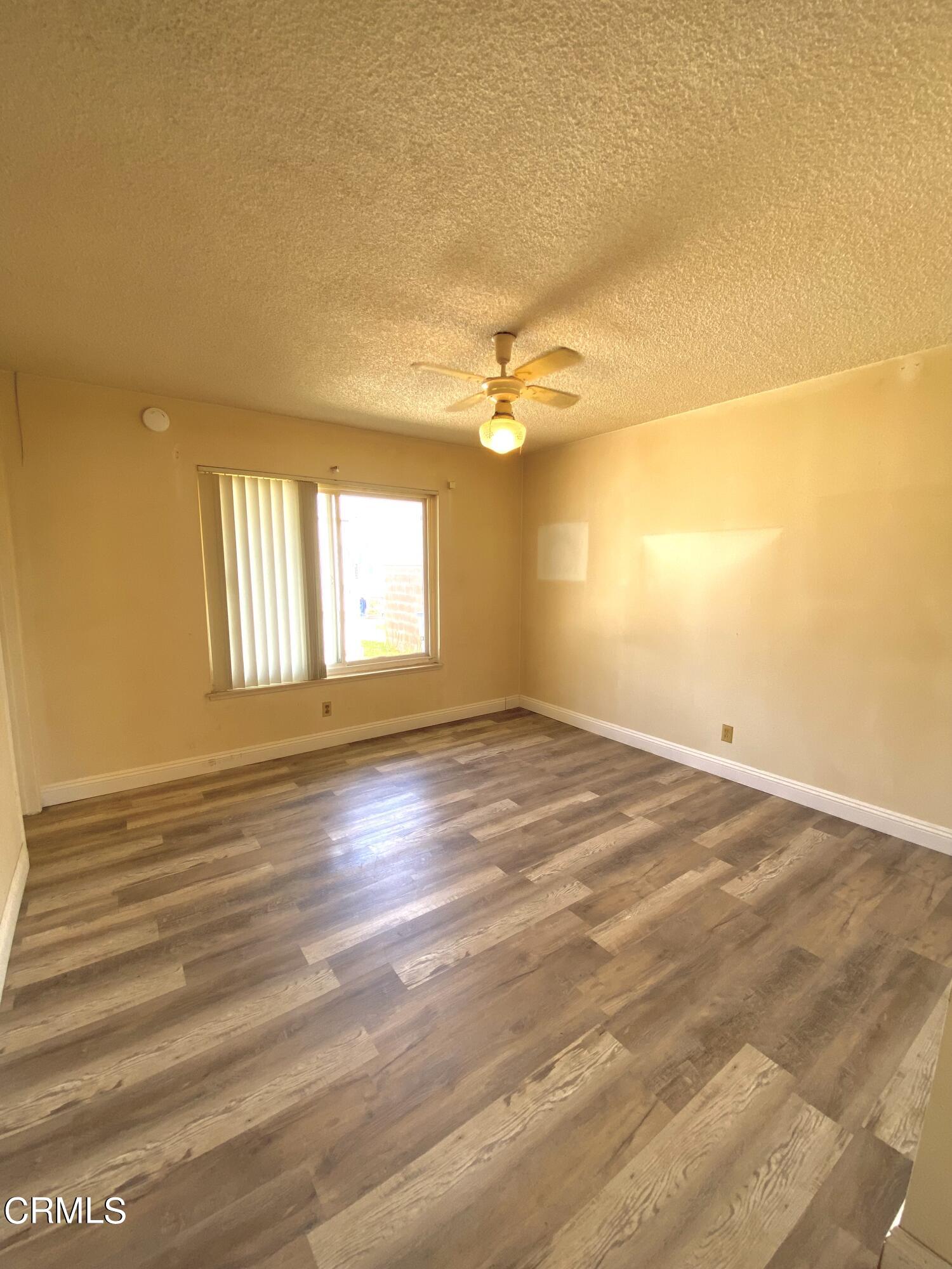 930 West Olive Street Oxnard, CA 93033 - Photo 18 of 22 an empty room with wooden floor and windows