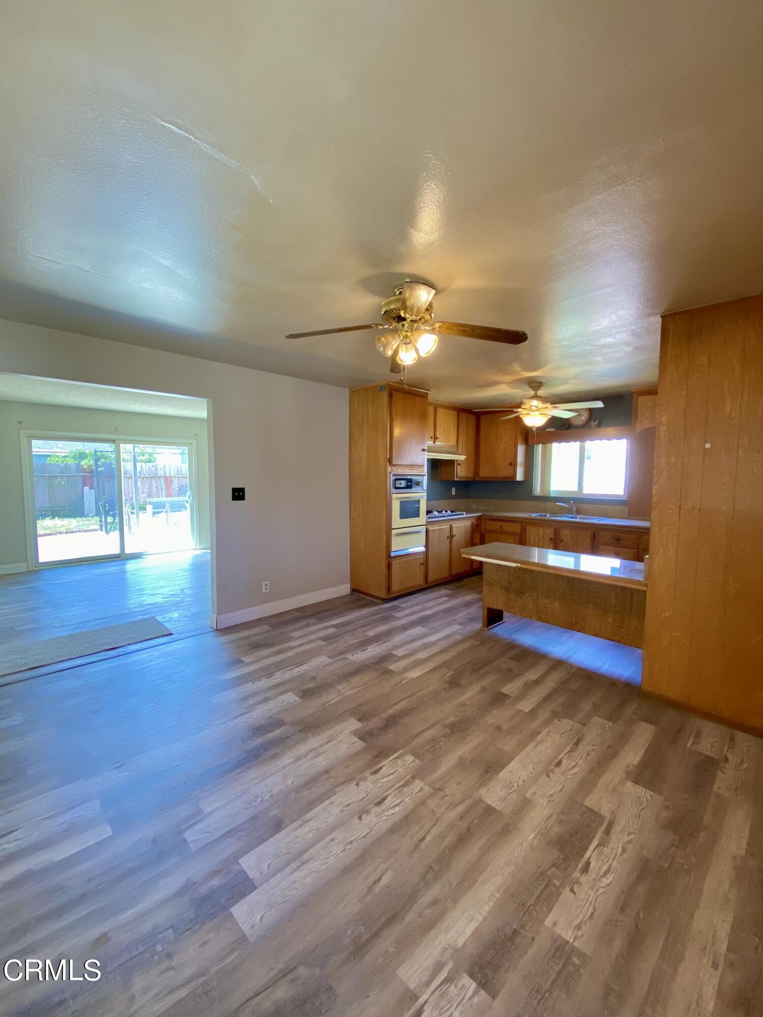 930 West Olive Street Oxnard, CA 93033 - Photo 7 of 22 a view of livingroom with hardwood floor and a ceiling fan