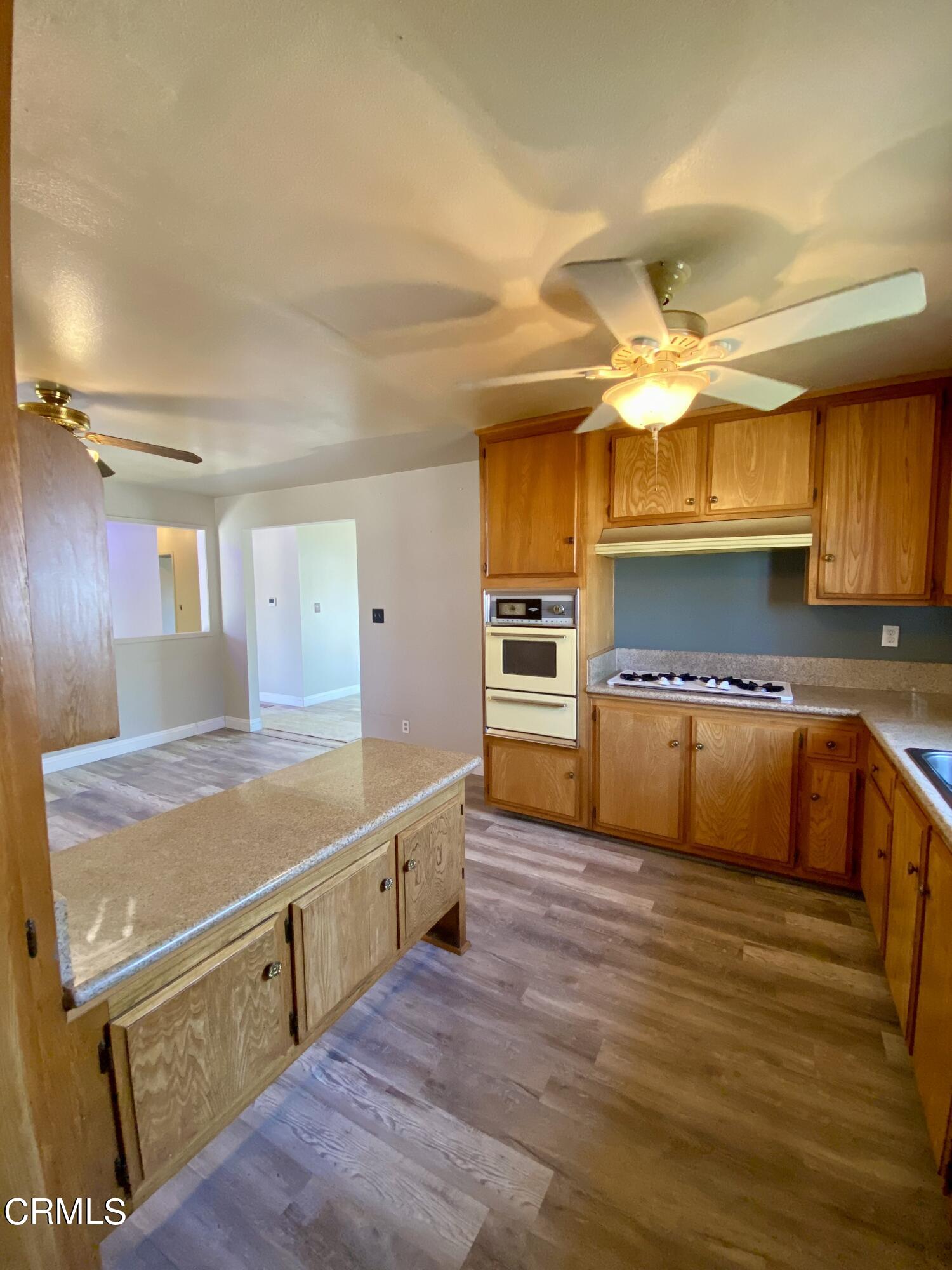 930 West Olive Street Oxnard, CA 93033 - Photo 9 of 22 a kitchen with stainless steel appliances granite countertop a sink and a stove