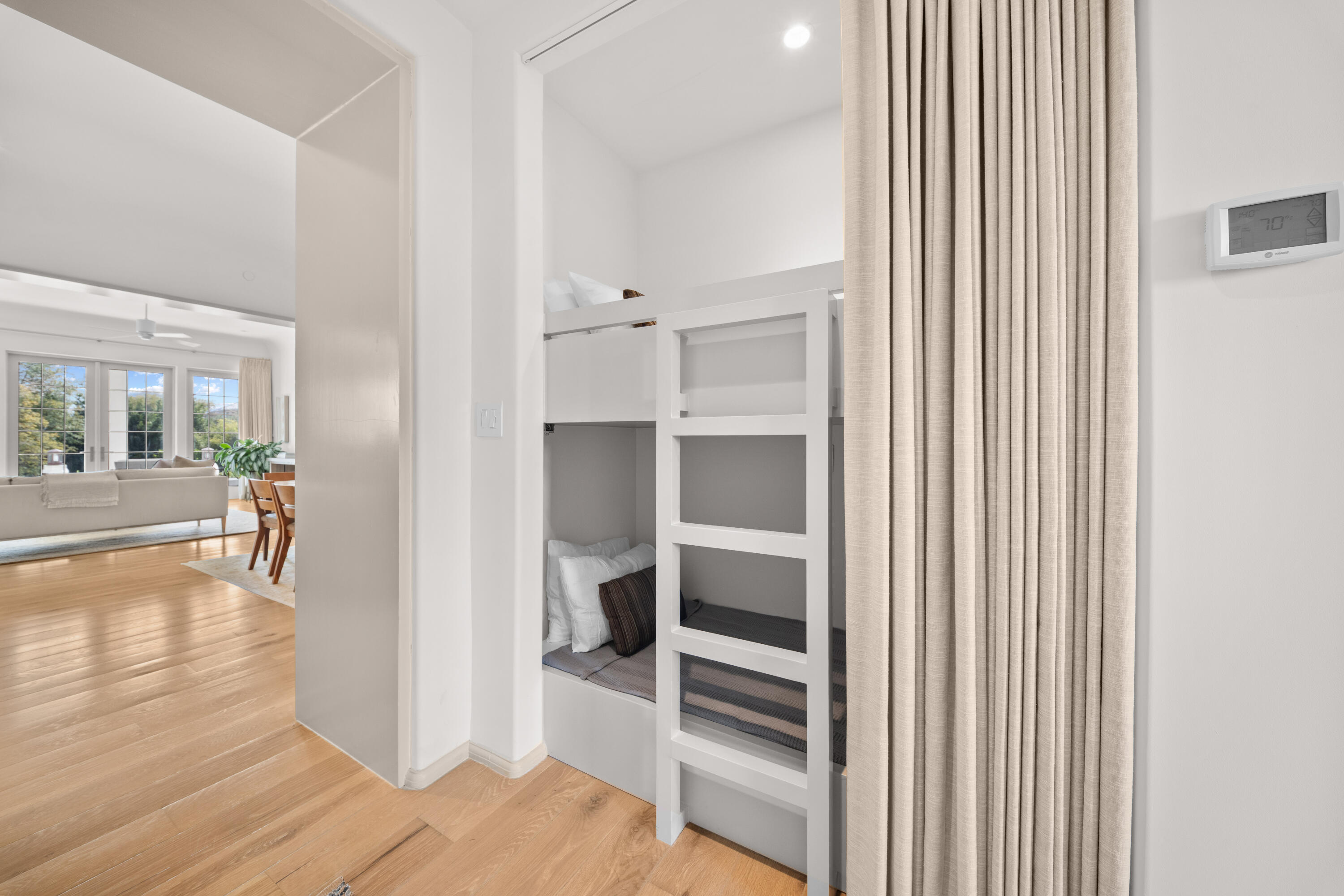 45 West Solaire Way Inlet Beach, Unit 107 Inlet Beach, FL 32461 - Photo 18 of 47 a view of a hallway with wooden floor and a living room