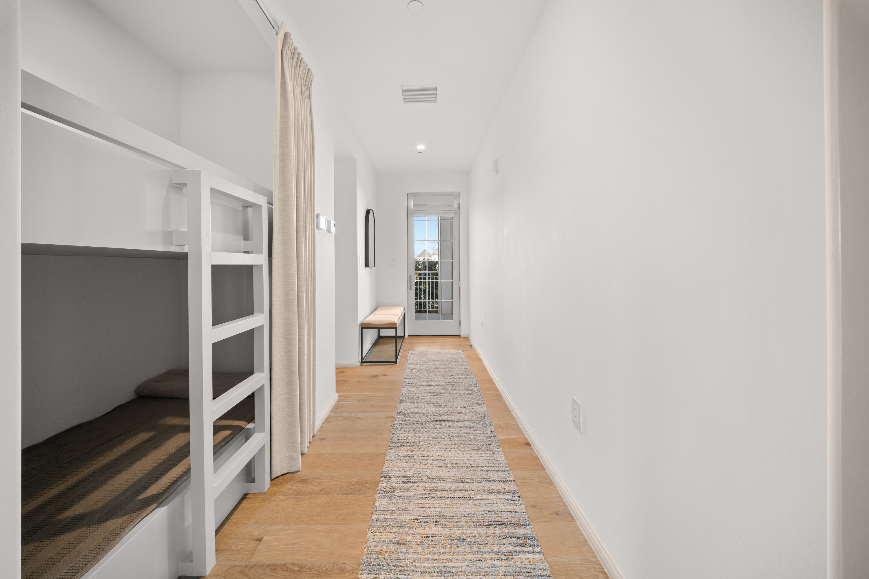 45 West Solaire Way Inlet Beach, Unit 107 Inlet Beach, FL 32461 - Photo 19 of 47 a view of a hallway with wooden floor and staircase