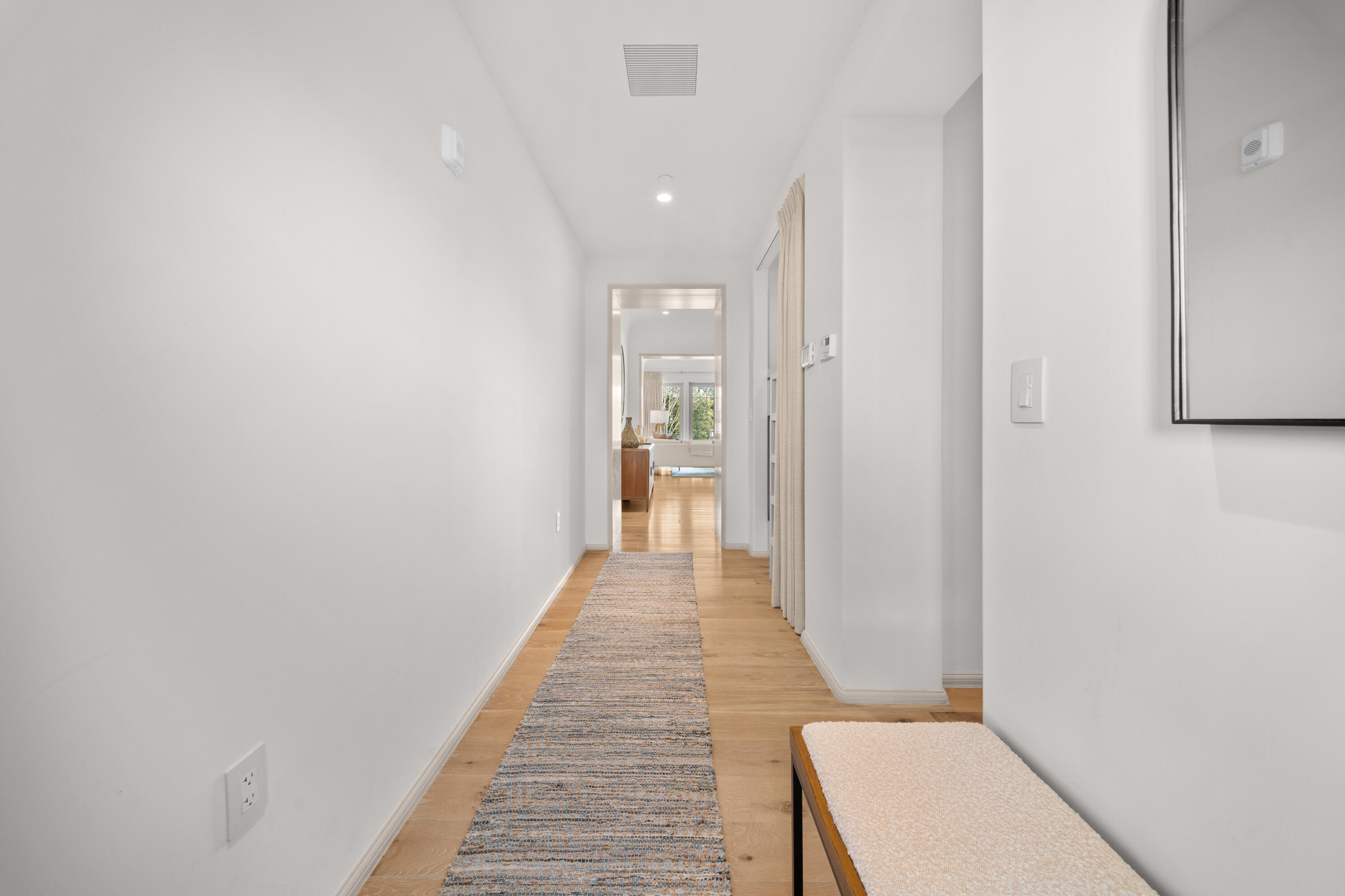 45 West Solaire Way Inlet Beach, Unit 107 Inlet Beach, FL 32461 - Photo 20 of 47 a view of a hallway with wooden floor and a bathroom