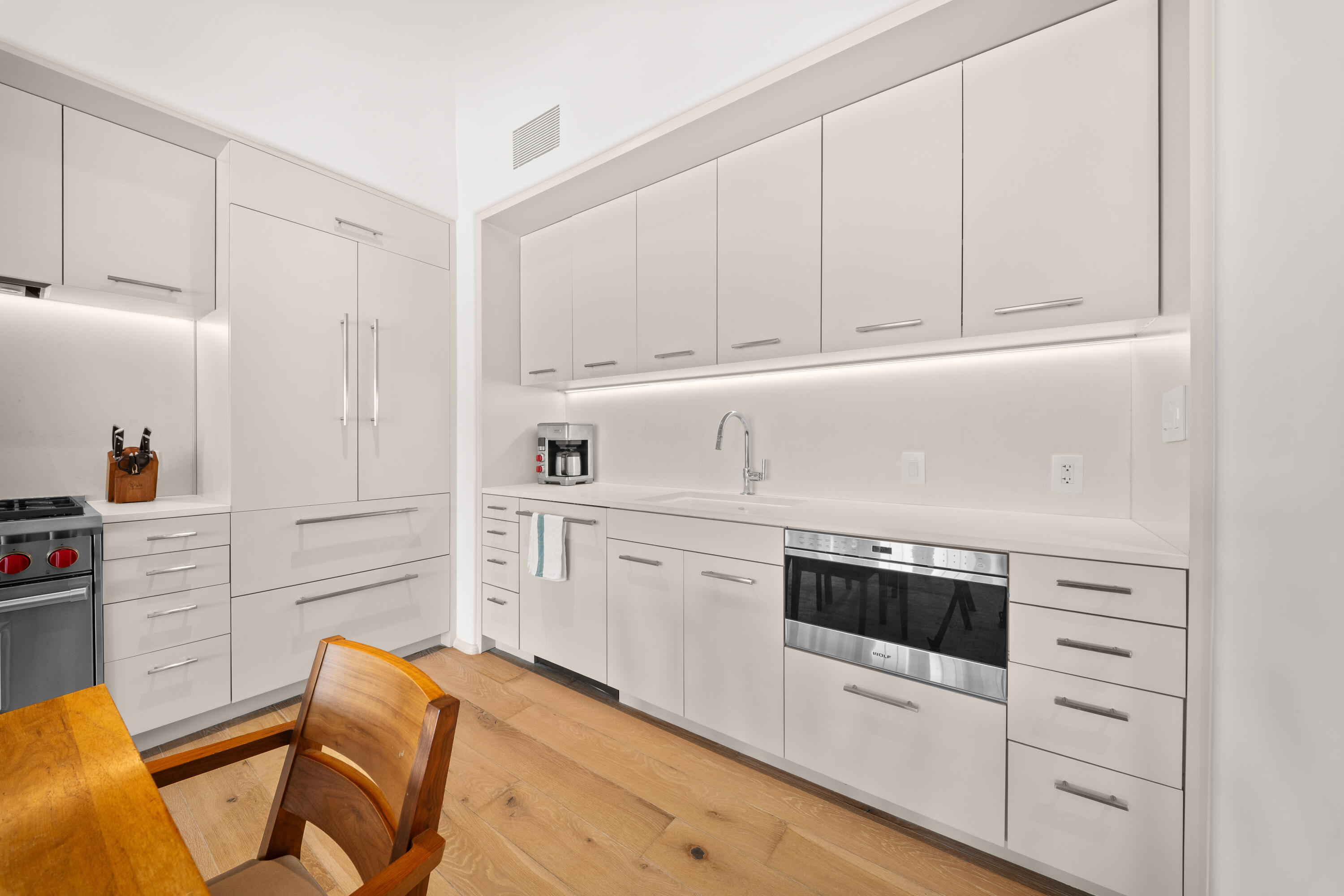 45 West Solaire Way Inlet Beach, Unit 107 Inlet Beach, FL 32461 - Photo 22 of 47 a kitchen with white cabinets and white appliances