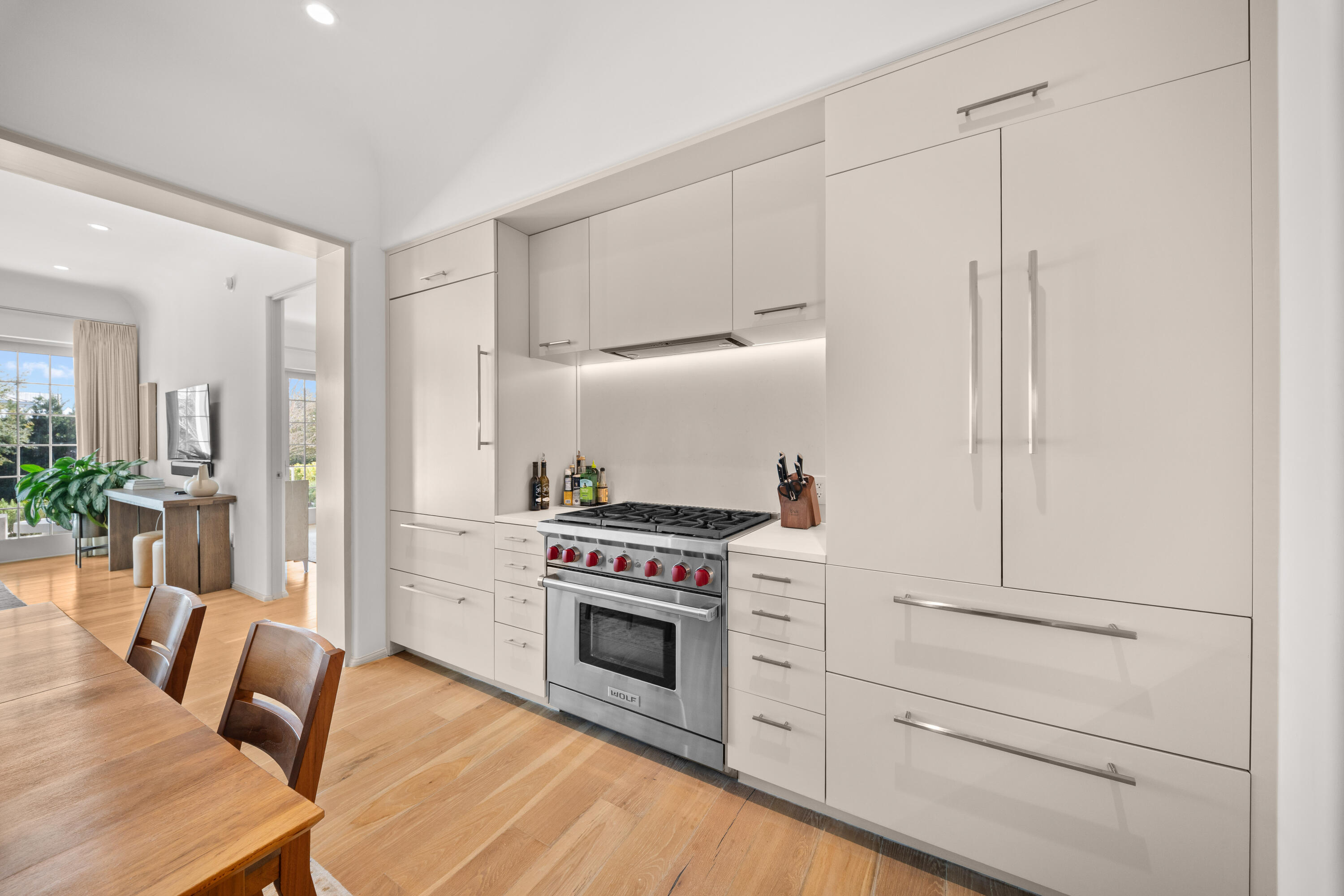 45 West Solaire Way Inlet Beach, Unit 107 Inlet Beach, FL 32461 - Photo 26 of 47 a kitchen with stainless steel appliances a stove a table and chairs