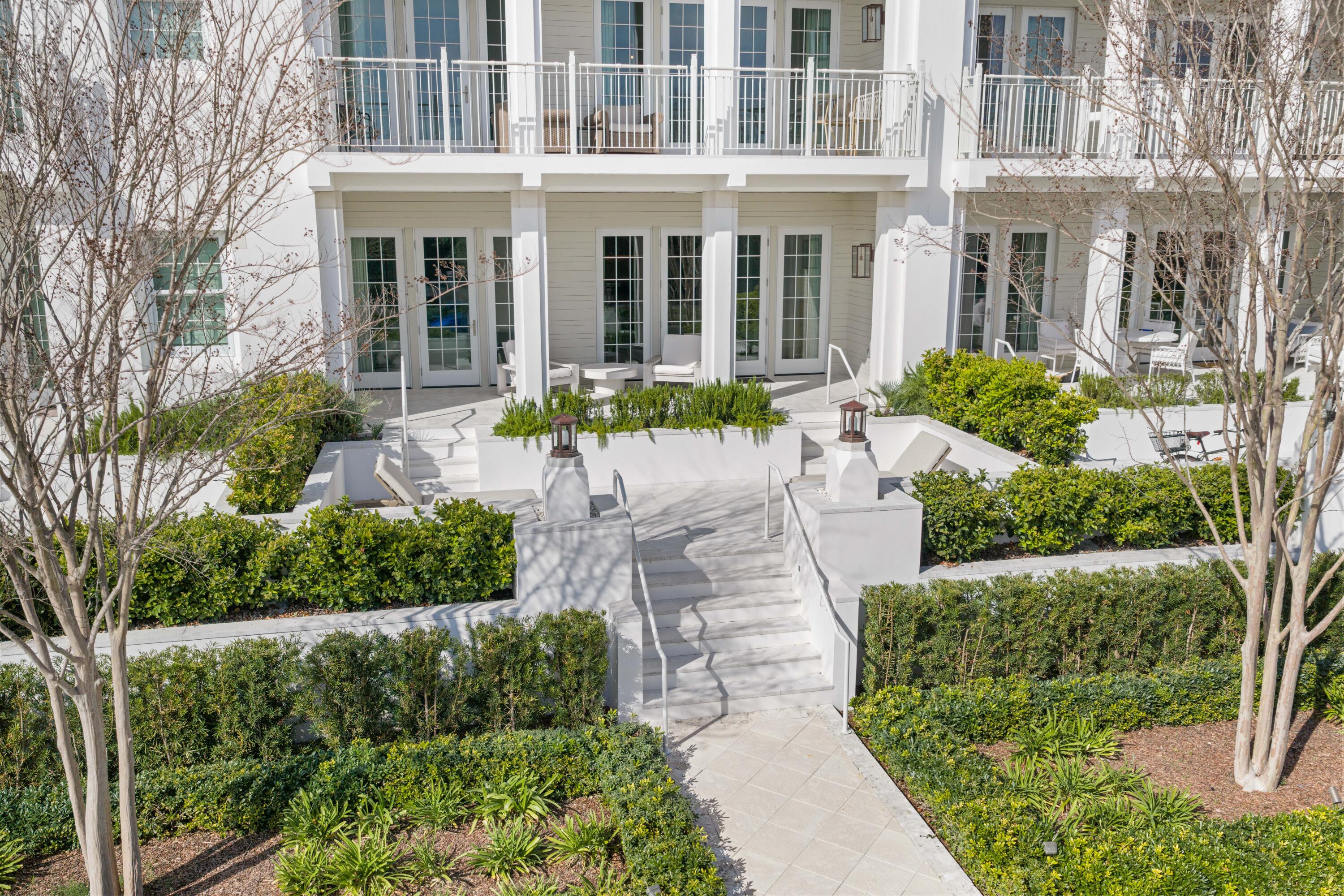 45 West Solaire Way Inlet Beach, Unit 107 Inlet Beach, FL 32461 - Photo 42 of 47 a front view of a multi story residential apartment building with a yard