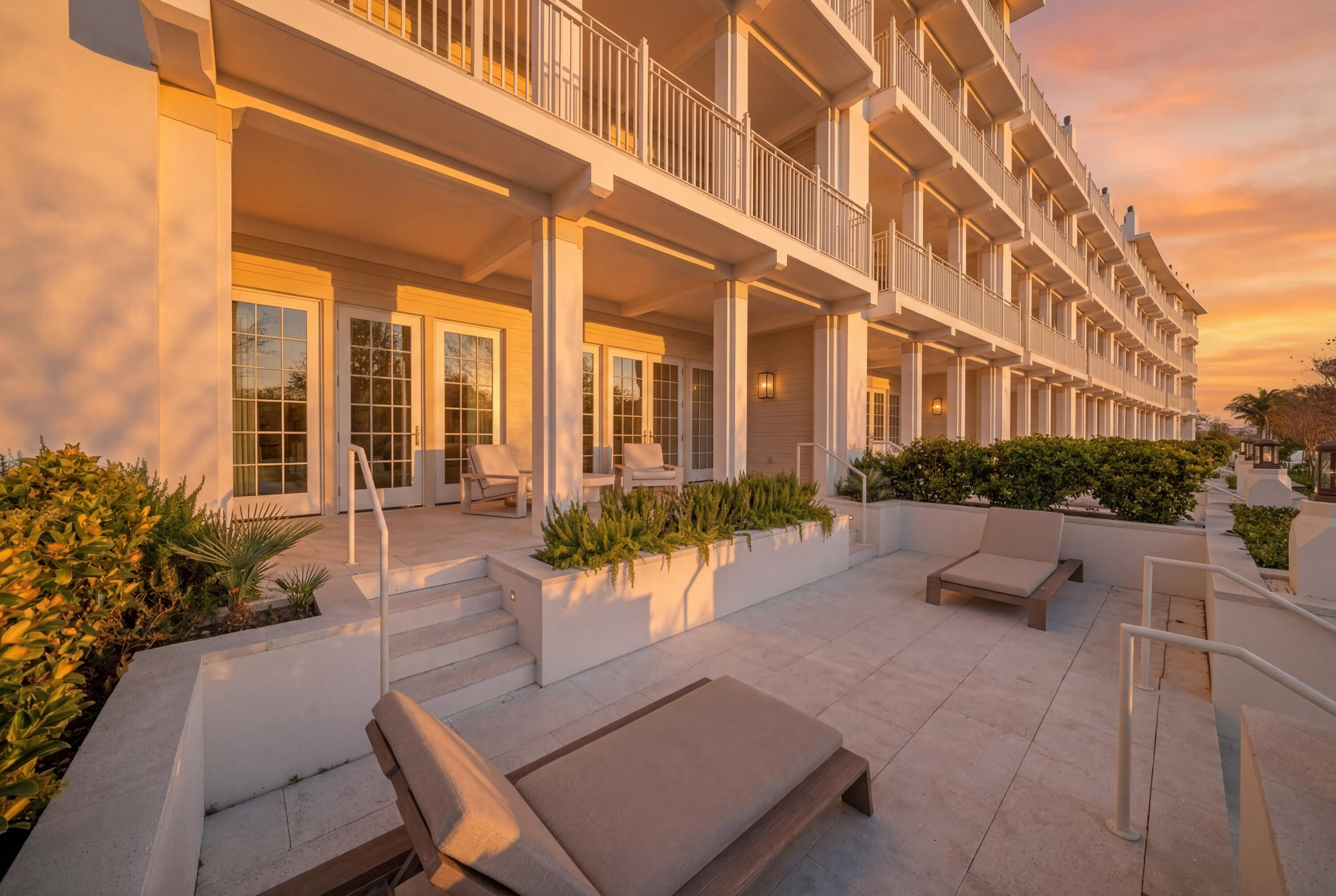 45 West Solaire Way Inlet Beach, Unit 107 Inlet Beach, FL 32461 - Photo 45 of 47 a building outdoor space with patio furniture and potted plants