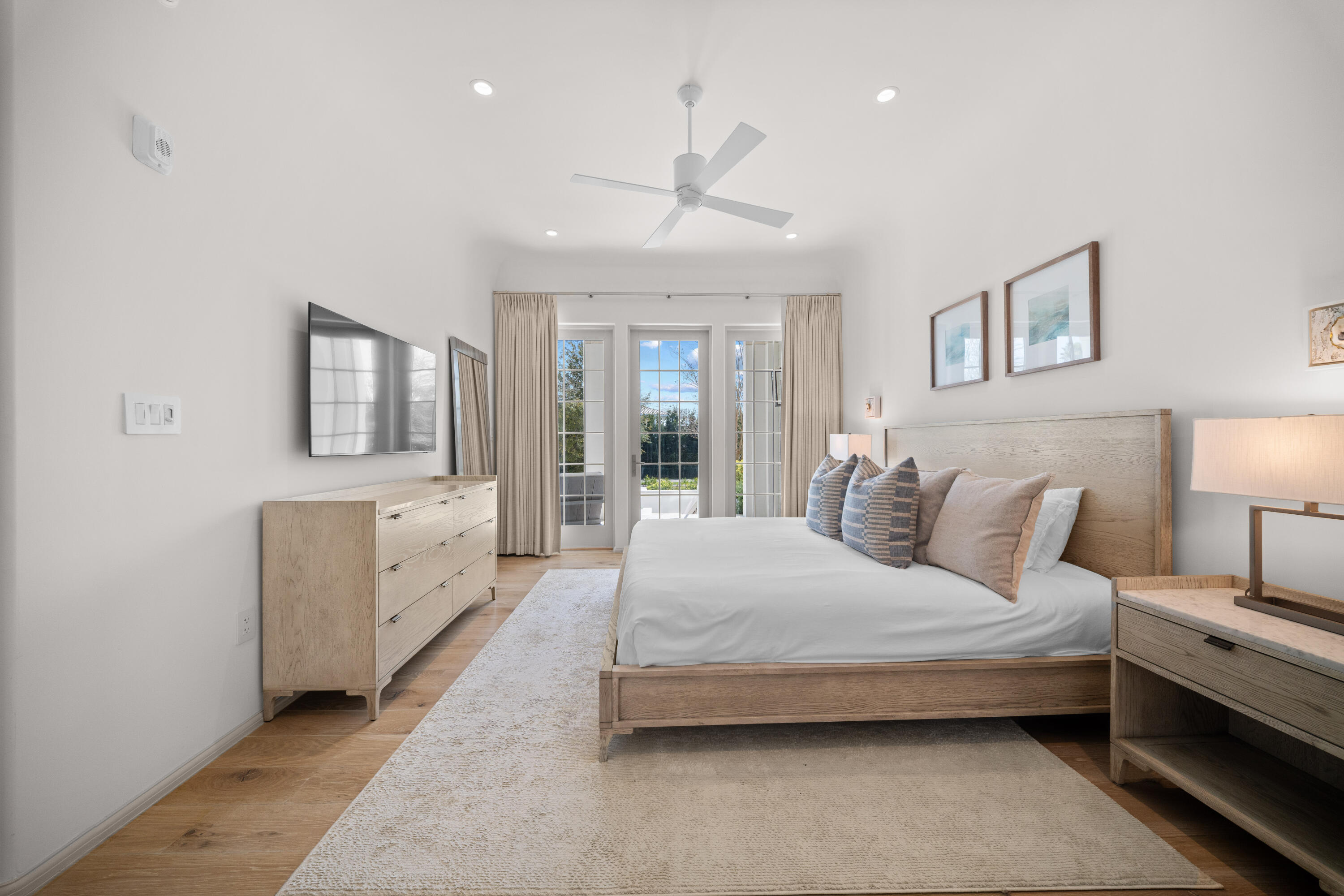 45 West Solaire Way Inlet Beach, Unit 107 Inlet Beach, FL 32461 - Photo 7 of 47 a spacious bedroom with a large bed and a chandelier