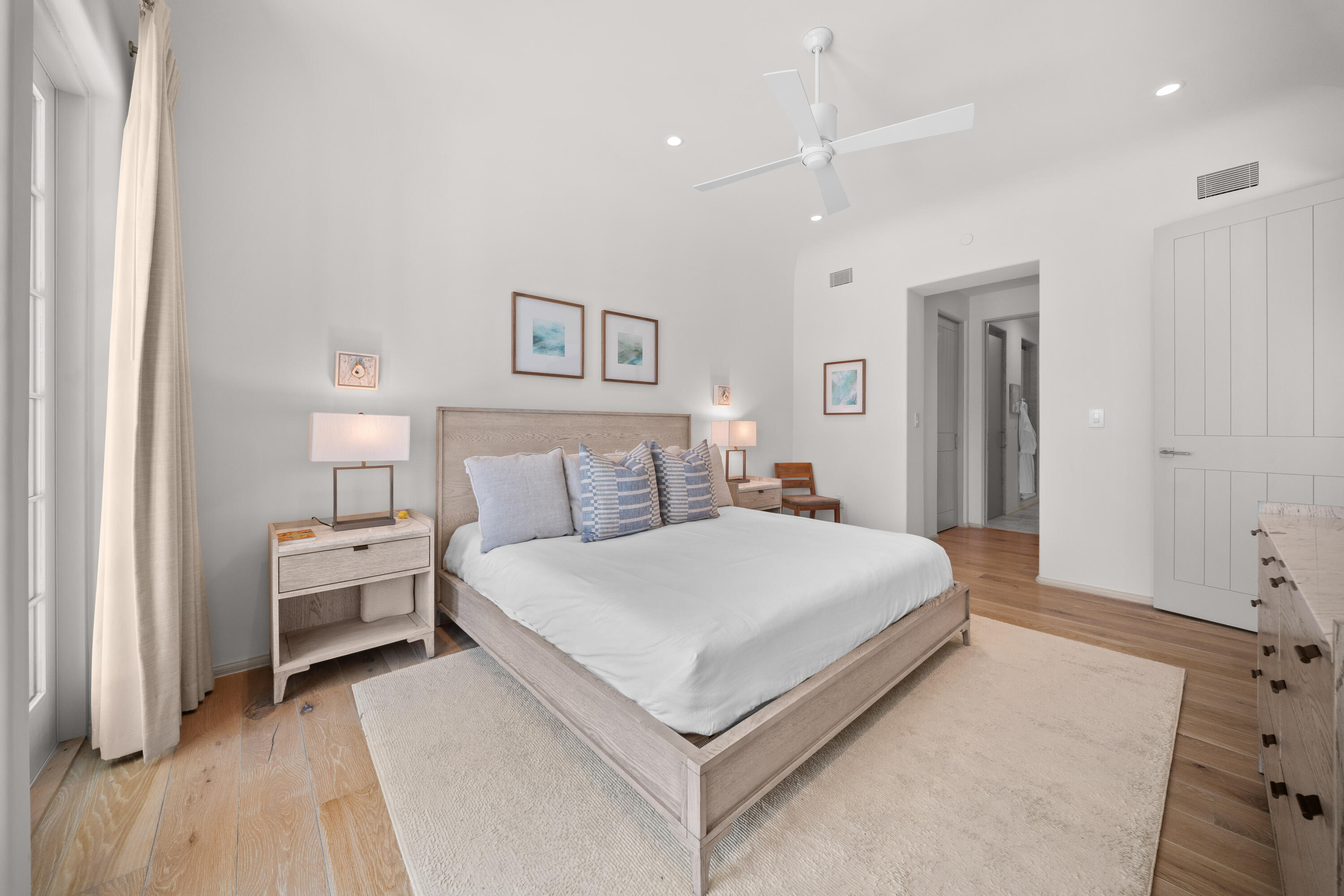 45 West Solaire Way Inlet Beach, Unit 107 Inlet Beach, FL 32461 - Photo 8 of 47 a spacious bedroom with a bed and a lamp