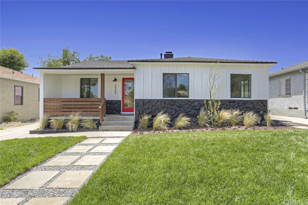 a front view of a house with a yard