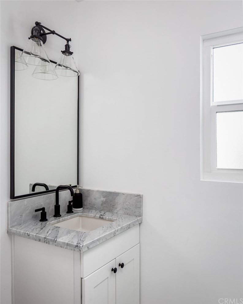 2589 El Sol Avenue Altadena, CA 91001 - Photo 18 of 28 a bathroom with a granite countertop sink and a mirror