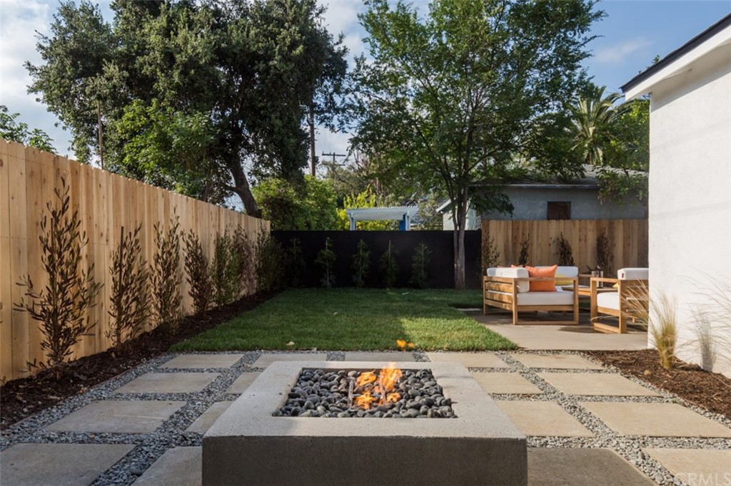 2589 El Sol Avenue Altadena, CA 91001 - Photo 21 of 28 a view of backyard with a table and chairs with wooden fence