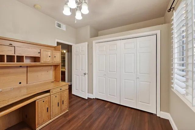 a kitchen with stainless steel appliances granite countertop a stove a sink and a refrigerator with wooden floors