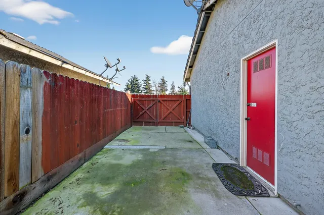 a view of a house with potted plants