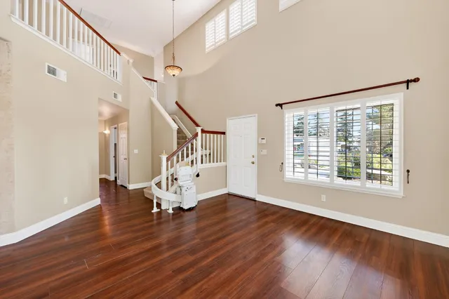 a view of an entryway with wooden floor and door