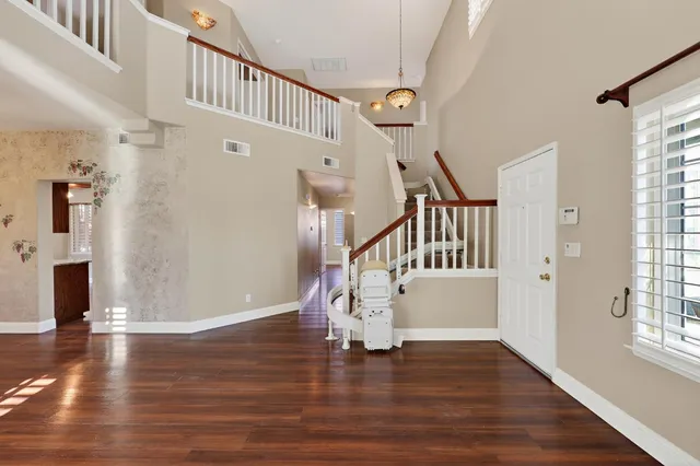 a view of entryway and hall with wooden floor