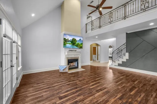a view of a livingroom with wooden floor and a fireplace