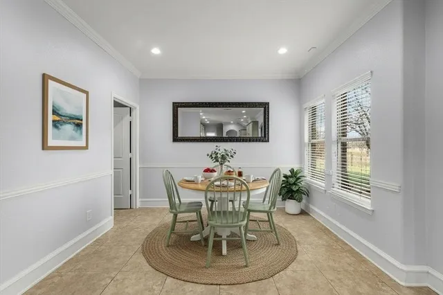 a dining room with furniture and window