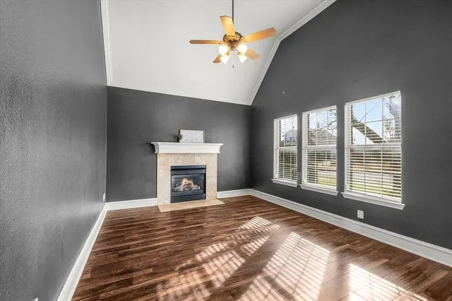 a view of an empty room with a fireplace and a window