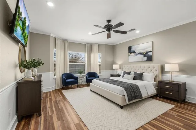 a bedroom with a bed and a chandelier