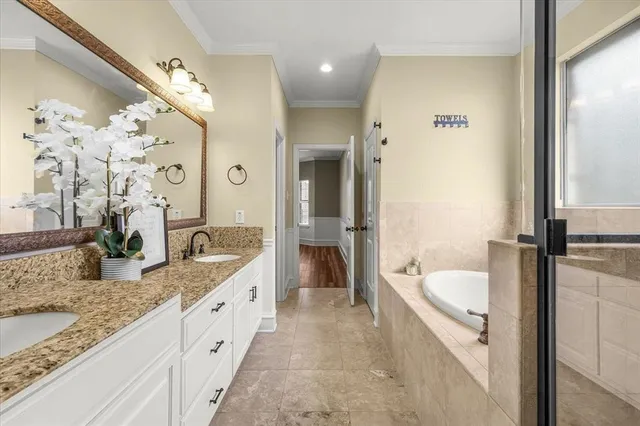 a spacious bathroom with a granite countertop tub sink and mirror