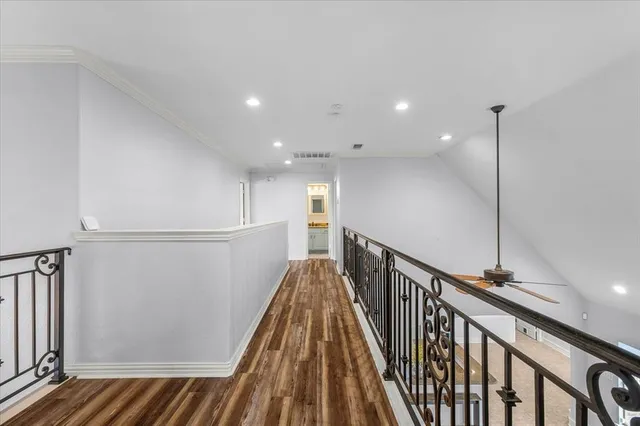 a view of a hallway with wooden floor