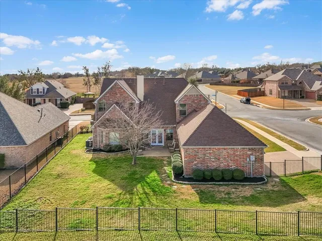 a aerial view of a house with a yard