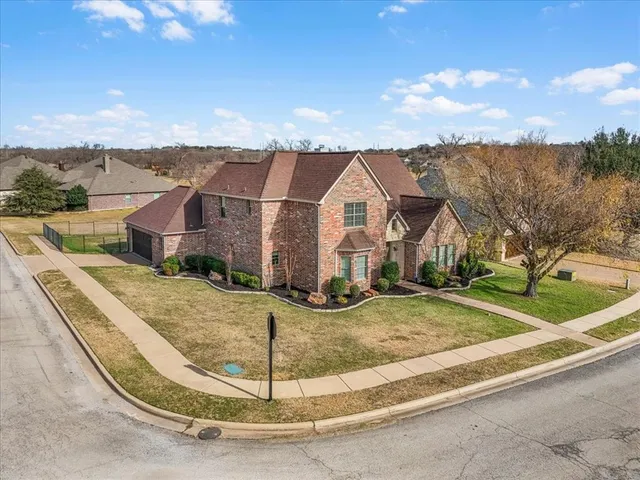 a view of a house with a wrought fence