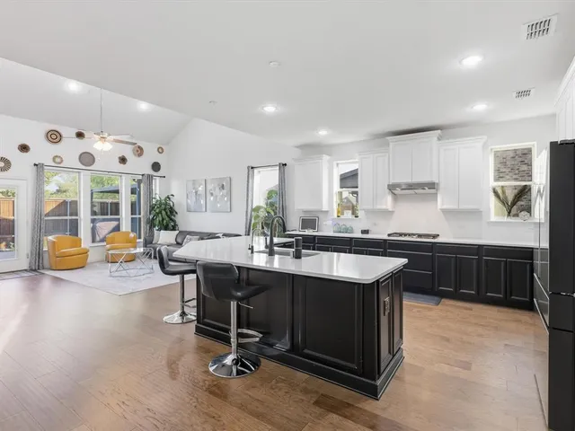 a kitchen with a sink a counter top space and stainless steel appliances
