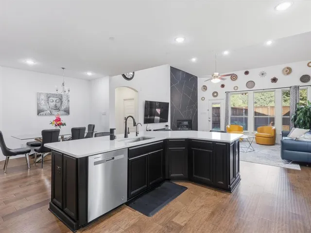 a kitchen with stainless steel appliances granite countertop a sink and a stove