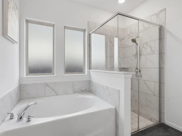 a bathroom with a bathtub and shower