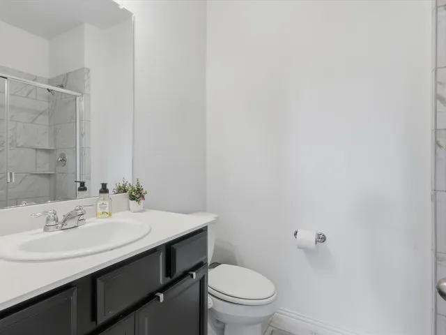 a bathroom with a sink a toilet and a mirror