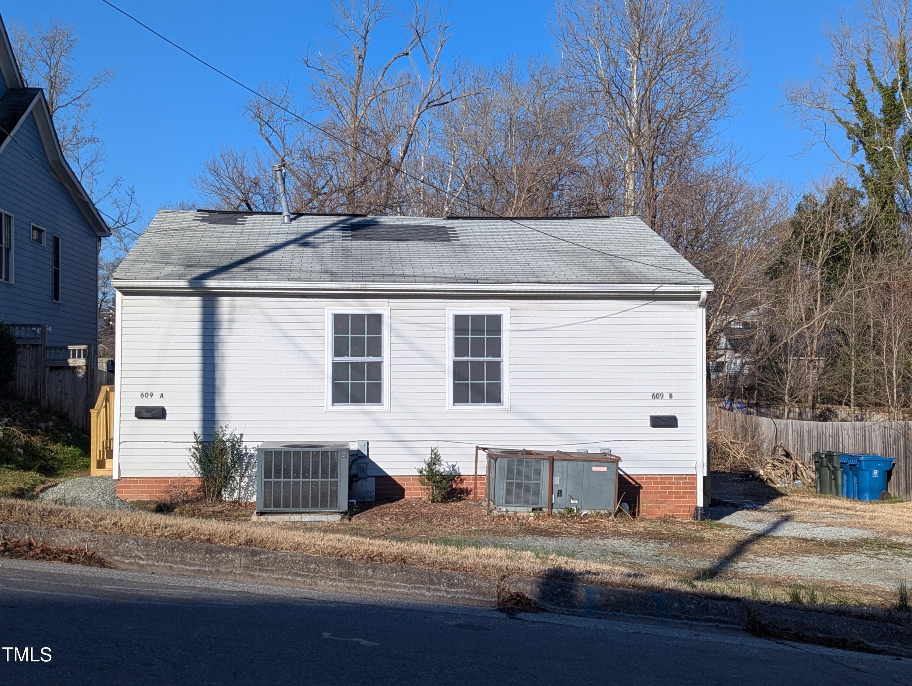 a view of a house with a yard covered in snow